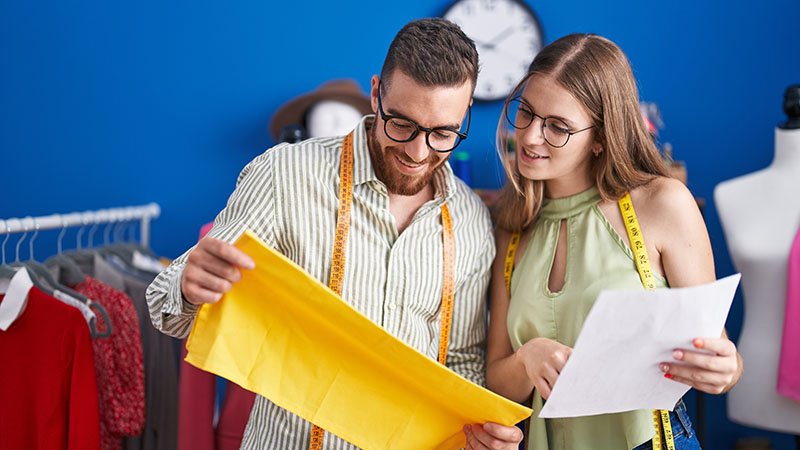 A quality control inspector checking a finished pair of leggings