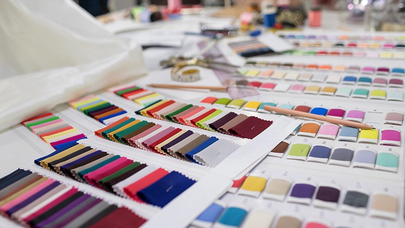 A collection of colorful high-performance activewear fabric swatches