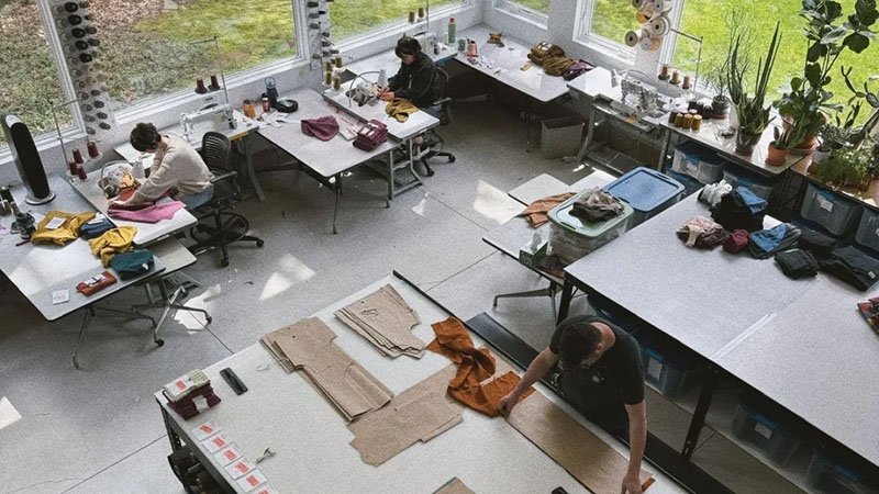 Launching a Sportswear Line A clothing designer sketching sportswear designs on a tablet in a modern studio.